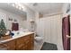 Traditional bathroom features oak vanity, white tile floor, neutral paint and combined tub/shower at 604 Clearwater Ct, Mcdonough, GA 30252