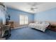 Bedroom featuring blue-and-beige walls, carpet flooring, and a shuttered window at 604 Clearwater Ct, Mcdonough, GA 30252