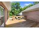 Spacious wooden deck perfect for outdoor gatherings, surrounded by lush greenery, and brick house at 604 Clearwater Ct, Mcdonough, GA 30252