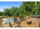 Wooden deck with patio furniture and grill overlooks a wooded yard, ideal for entertaining guests at 604 Clearwater Ct, Mcdonough, GA 30252