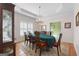An elegant dining room features tray ceiling, hardwood floors, and large windows for ample light at 604 Clearwater Ct, Mcdonough, GA 30252