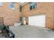 Exterior view features a brick facade and a two-car garage, with a spacious driveway for parking at 604 Clearwater Ct, Mcdonough, GA 30252