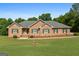 Charming brick home with green shutters, well-manicured lawn and beautiful landscaping at 604 Clearwater Ct, Mcdonough, GA 30252