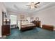 Spacious main bedroom with tray ceilings, carpet floors, natural light, and traditional furnishings at 604 Clearwater Ct, Mcdonough, GA 30252
