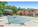 Pool with a cover on it, patio seating, and the house with a back deck at 604 Clearwater Ct, Mcdonough, GA 30252