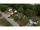 Aerial view shows this suburban house set among lush greenery in a quiet neighborhood at 70 Summer Walk Dr, Covington, GA 30016