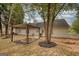 Beautiful backyard view showcases the pergola, fire pit, spacious lawn, and mature trees at 70 Summer Walk Dr, Covington, GA 30016