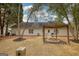 Backyard view showcases a pergola with fire pit, lush trees, and well-maintained lawn at 70 Summer Walk Dr, Covington, GA 30016
