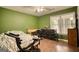 Cozy bedroom features hardwood floors, natural light, and ample space for a desk and home exercise equipment at 70 Summer Walk Dr, Covington, GA 30016