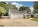 Attractive home showcasing a two-car garage, brick accents, mature trees, and a well-manicured front yard at 70 Summer Walk Dr, Covington, GA 30016