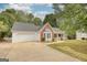 Well-maintained home featuring a two-car garage, brick detailing, and manicured landscaping at 70 Summer Walk Dr, Covington, GA 30016