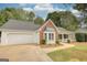 Beautiful one-story home featuring a brick accent, attached two-car garage, and a welcoming front porch at 70 Summer Walk Dr, Covington, GA 30016
