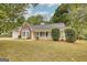 Inviting home with a charming front porch, well-kept lawn, and mature landscaping creating a welcoming curb appeal at 70 Summer Walk Dr, Covington, GA 30016