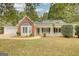 Charming single-story home featuring a brick facade, bay window, well-maintained lawn, and a cozy front porch at 70 Summer Walk Dr, Covington, GA 30016
