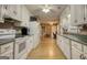 Bright kitchen features white cabinets, laminate floors, and appliances at 70 Summer Walk Dr, Covington, GA 30016