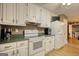 Kitchen with white cabinets, green countertops, and appliances at 70 Summer Walk Dr, Covington, GA 30016