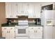 Kitchen features white appliances and cabinets with modern style at 70 Summer Walk Dr, Covington, GA 30016