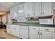 Kitchen view showcasing white cabinets and laminate flooring at 70 Summer Walk Dr, Covington, GA 30016