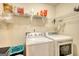 Bright laundry room featuring a washer, dryer, and plenty of storage space for supplies at 70 Summer Walk Dr, Covington, GA 30016