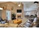 Comfortable living room featuring a brick fireplace and an open layout to the dining area at 70 Summer Walk Dr, Covington, GA 30016