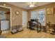 Tan office has a desk, chair, two windows, and a fan at 70 Summer Walk Dr, Covington, GA 30016