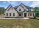 Beautiful new construction home featuring a covered porch, professional landscaping, and modern brickwork at 1465 Leach Dr, Lawrenceville, GA 30045