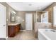 Bathroom with a soaking tub, shower, and vanity with granite counters at 71 Pacific Ave, Sharpsburg, GA 30277
