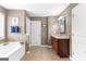 Spacious bathroom features tile floors, double door linen closet, soaking tub and vanity at 71 Pacific Ave, Sharpsburg, GA 30277