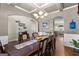 The dining room has hardwood floors, wainscotting, a coffered ceiling, and a view into other rooms at 71 Pacific Ave, Sharpsburg, GA 30277