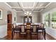 Elegant dining room featuring a coffered ceiling, hardwood floors, and stylish furnishings for Gathering gatherings at 71 Pacific Ave, Sharpsburg, GA 30277
