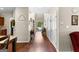 Hallway featuring hardwood floors and decorative touches, leading to the home's various living spaces at 71 Pacific Ave, Sharpsburg, GA 30277