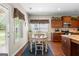 Eat-in kitchen with stainless appliances, wood cabinets, and a view of the backyard at 71 Pacific Ave, Sharpsburg, GA 30277
