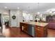Kitchen featuring stainless appliances, a large island, and hardwood floors at 71 Pacific Ave, Sharpsburg, GA 30277