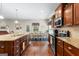 Kitchen featuring stainless appliances, granite countertops, hardwood floors, and wood cabinets at 71 Pacific Ave, Sharpsburg, GA 30277