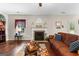 Cozy living room featuring a fireplace, hardwood floors and ample natural light at 71 Pacific Ave, Sharpsburg, GA 30277