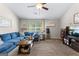 Comfortable living room featuring a cozy sofa, throw pillows and natural light at 71 Pacific Ave, Sharpsburg, GA 30277