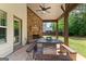 Covered outdoor space boasting a stone fireplace, dining table, and bench seating at 71 Pacific Ave, Sharpsburg, GA 30277