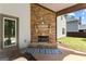 Outdoor porch featuring a stacked stone fireplace and a view of the backyard at 71 Pacific Ave, Sharpsburg, GA 30277