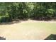 Lush backyard with mature trees creating a private and serene outdoor space at 300 Cloverwood Dr, Fayetteville, GA 30215