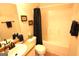 Standard bathroom with a shower-tub, toilet, vanity, framed mirror, and a towel bar at 300 Cloverwood Dr, Fayetteville, GA 30215