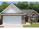 Charming brick home with an attached two-car garage and a well-maintained front lawn at 300 Cloverwood Dr, Fayetteville, GA 30215