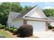 A well-maintained home with a two-car garage and landscaped shrubbery at 300 Cloverwood Dr, Fayetteville, GA 30215