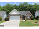 Charming brick and vinyl home with a two-car garage and well-manicured lawn at 300 Cloverwood Dr, Fayetteville, GA 30215