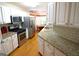 Well-lit kitchen with stainless steel appliances, granite countertops, and white cabinets overlooking the breakfast nook at 300 Cloverwood Dr, Fayetteville, GA 30215