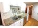 Updated kitchen with granite countertops, stainless steel appliances, and subway tile backsplash at 300 Cloverwood Dr, Fayetteville, GA 30215