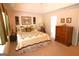 Comfortable main bedroom with tray ceiling, neutral colors, and soft carpeting at 300 Cloverwood Dr, Fayetteville, GA 30215