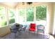 Cozy sunroom with large windows and outdoor views, perfect for relaxing and enjoying nature at 300 Cloverwood Dr, Fayetteville, GA 30215