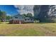 Spacious backyard featuring the home's back exterior with blue siding, brick accents, and lush greenery at 1102 Tony Valley Se Dr, Conyers, GA 30013