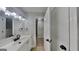 Bright bathroom with a large mirror, modern vanity, and fresh white cabinets with modern black fixtures at 1102 Tony Valley Se Dr, Conyers, GA 30013