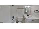 Bright bathroom featuring a shower and tub combo with black fixtures, a modern vanity, and fresh white cabinets at 1102 Tony Valley Se Dr, Conyers, GA 30013